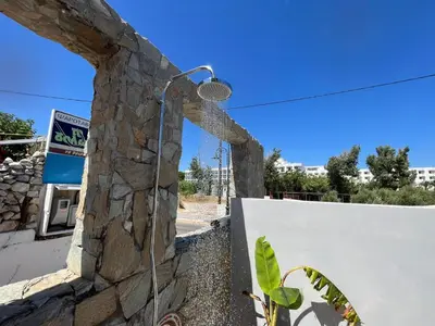 a shower built into a stone wall at Nesèa Apartment Faliraki in Faliraki