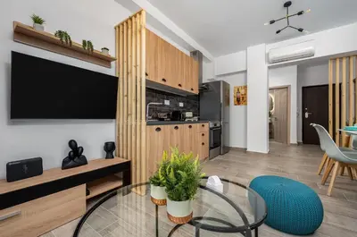 a living room with a tv and a glass table at Nice n Cosy Apartment I in Rhodes Town