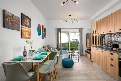 a kitchen and dining room with a table and chairs at Nice n Cosy Apartment I in Rhodes Town