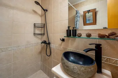 a bathroom with a sink and a shower at El Paradiso in Pastida