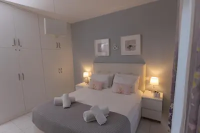 a bedroom with a large white bed with two pillows at Silver Palm House Ixia, Rhodes in Ixia