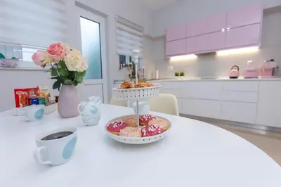 a table with a bowl of donuts and a cup of coffee at Silver Palm House Ixia, Rhodes in Ixia