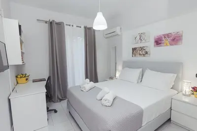 a white bedroom with a bed with towels on it at Silver Palm House Ixia, Rhodes in Ixia