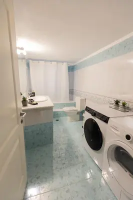 a white bathroom with a washing machine in it at Silver Palm House Ixia, Rhodes in Ixia