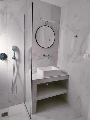 a white bathroom with a sink and a mirror at Alpha Villas in Gennadi