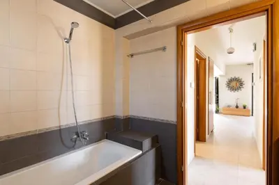 a bathroom with a tub and a walk in shower at Dioni Pool House in Ialyssos