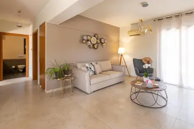 a living room with a couch and a table at Dioni Pool House in Ialyssos