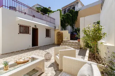 a courtyard of a house with white walls at Evaxenia's House Old Town Rhodes in Rhodes Town