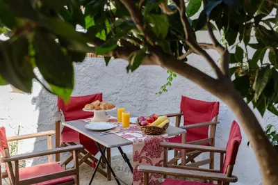 a table with a bowl of fruit on it at Evaxenia's House Old Town Rhodes in Rhodes Town