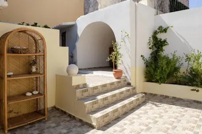 a courtyard with stairs and plants in a building at Evaxenia's House Old Town Rhodes in Rhodes Town