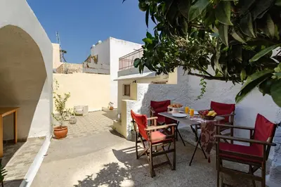 a patio with a table and chairs in a building at Evaxenia's House Old Town Rhodes in Rhodes Town