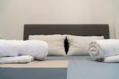 two rolls of towels on top of a bed at Aegean Stars in Rhodes Town