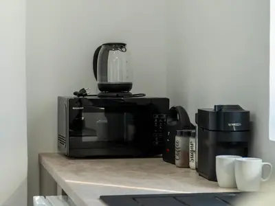 a microwave sitting on top of a kitchen counter at Aegean Stars in Rhodes Town