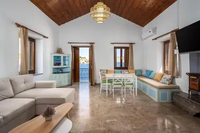 a living room with a couch and a table at Petalo House in Symi