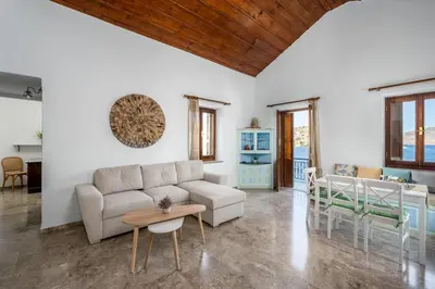 a living room with a couch and a table at Petalo House in Symi