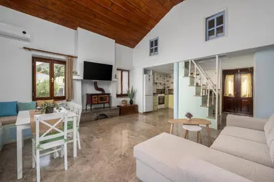 a living room with a couch and a table at Petalo House in Symi