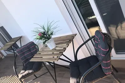 a table and chairs on a balcony with a potted plant at Appartement in Rhodos Stadt in Rhodes Town