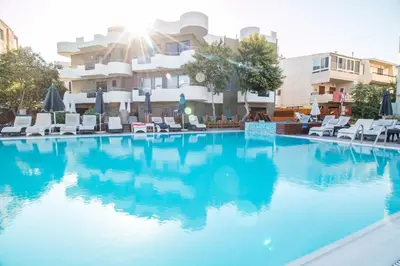 a large swimming pool in front of a building at Sunny Days Hotel in Ixia
