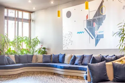 a blue couch in a living room with plants at Sunny Days Hotel in Ixia