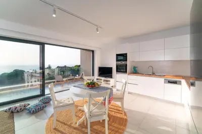 a kitchen and dining room with a table and chairs at Aquarama Pool Apts. in Ixia