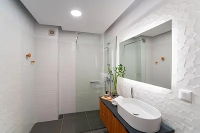 a white bathroom with a sink and a mirror at Aquarama Pool Apts. in Ixia