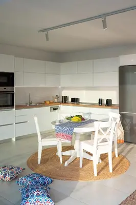 a kitchen with a table and two chairs in it at Aquarama Pool Apts. in Ixia