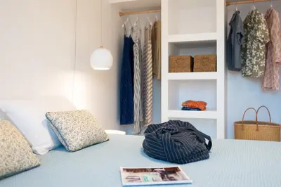 a bedroom with a blue bed with a magazine on it at Aquarama Pool Apts. in Ixia