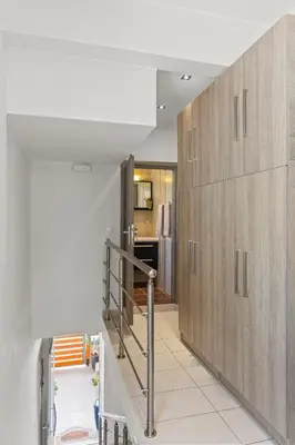 a hallway with wooden cabinets and a staircase in a house at Rhodian Filoxenia in Rhodes Town