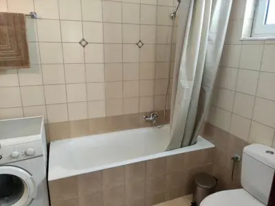a bathroom with a tub and a toilet and a sink at Casa Amalia in Paradeísion