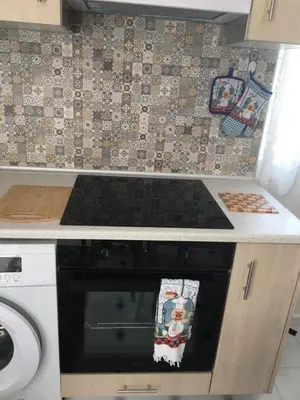 a kitchen with a stove top oven in a kitchen at Evelyn's Cozy Apartment in Rhodes Town