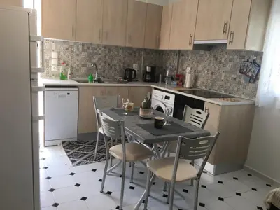 a kitchen with a table and chairs in it at Evelyn's Cozy Apartment in Rhodes Town