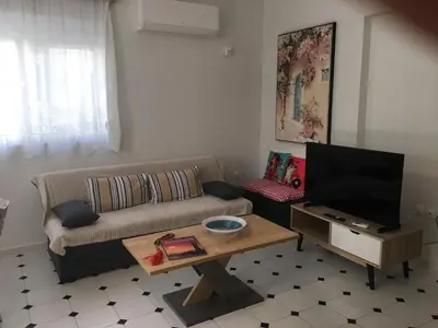 a living room with a couch and a coffee table at Evelyn's Cozy Apartment in Rhodes Town