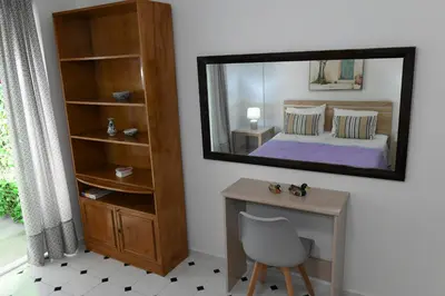 a bedroom with a mirror and a desk and a bed at Evelyn's Cozy Apartment in Rhodes Town