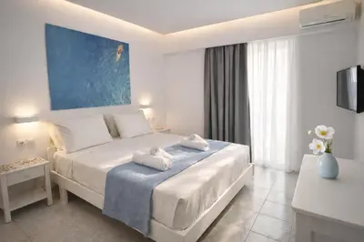 a hotel room with a bed with towels on it at Casa al' Tati Apartments in Ialyssos