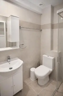a white bathroom with a toilet and a sink at Casa al' Tati Apartments in Ialyssos