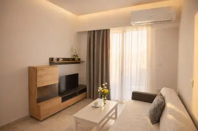 a living room with a couch and a television at Casa al' Tati Apartments in Ialyssos