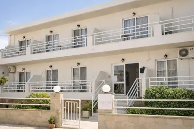 a white building with white balconies on it at Casa al' Tati Apartments in Ialyssos
