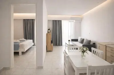 a white living room with a couch and a table at Casa al' Tati Apartments in Ialyssos