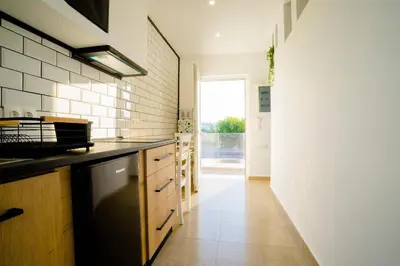 a kitchen with a sink and a dishwasher at Mousikorama Apartments in Faliraki