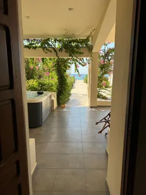 a hallway with a view of the ocean from a house at Amaryllis Beach House in Lardos