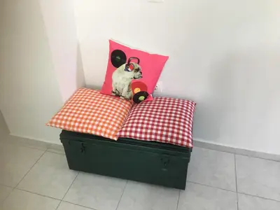 a dog sitting on top of two pillows at Emerald Cozy Apartment in Rhodes Town