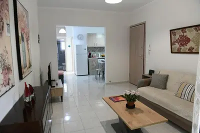 a living room with a couch and a table at Emerald Cozy Apartment in Rhodes Town