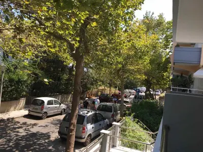 a group of cars parked in a parking lot at Emerald Cozy Apartment in Rhodes Town