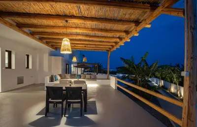 an outdoor dining area with a table and chairs on a house at Blue Di Mare Villas in Lachania