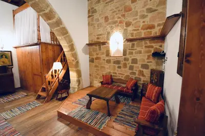a living room with a couch and a table at Villa Patitiri Traditional House with hot tub in Archangelos