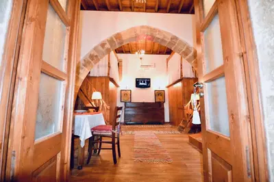 an archway leading to a dining room with a table at Villa Patitiri Traditional House with hot tub in Archangelos