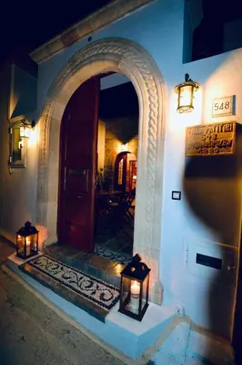 an entryway to a building with two lights on it at Villa Patitiri Traditional House with hot tub in Archangelos