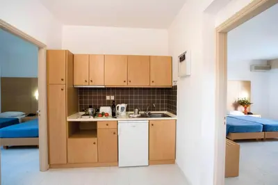 a kitchen with wooden cabinets in a room at Pefki Islands in Pefki Rhodes