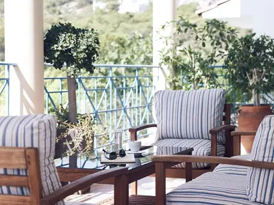 two chairs and a coffee table on a porch at Pefki Islands in Pefki Rhodes