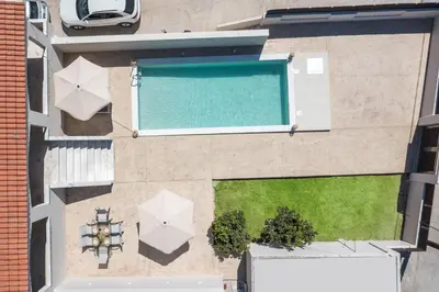 an overhead view of a swimming pool with umbrellas at Anastasia Luxury House in Afantou